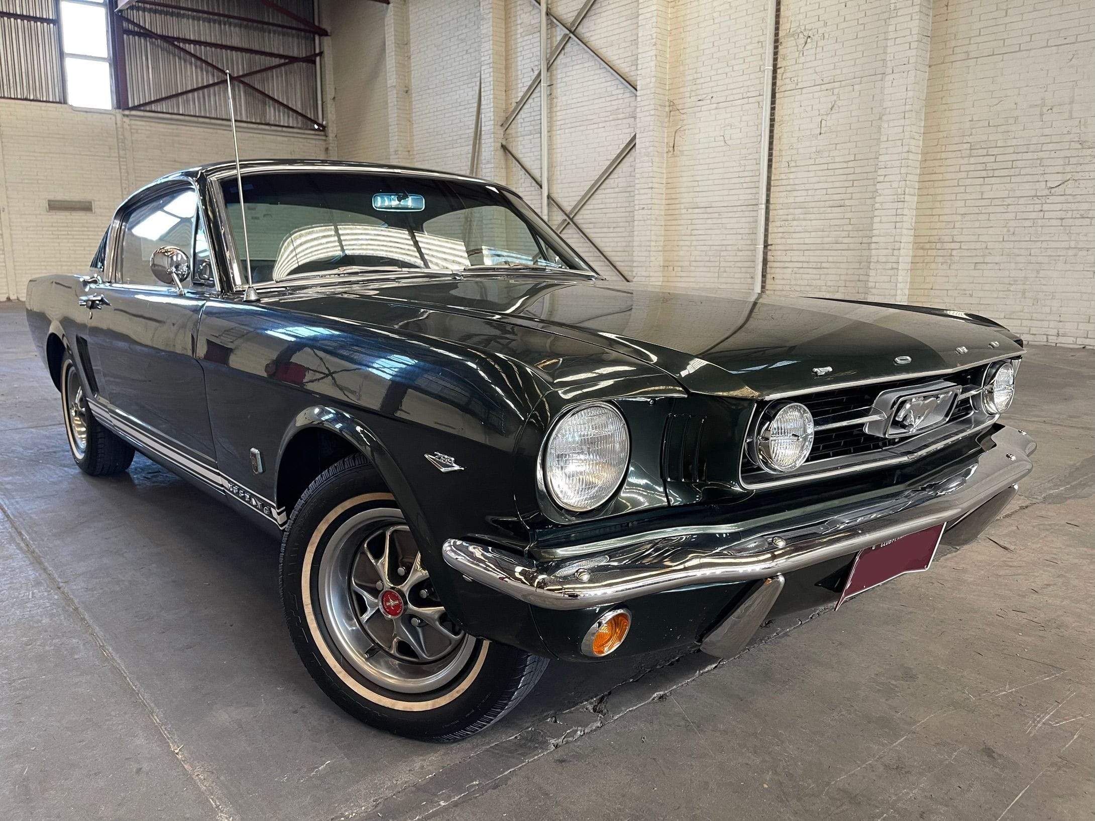 1966 Ford Mustang GT A-Code Fastback with a dark blue body.