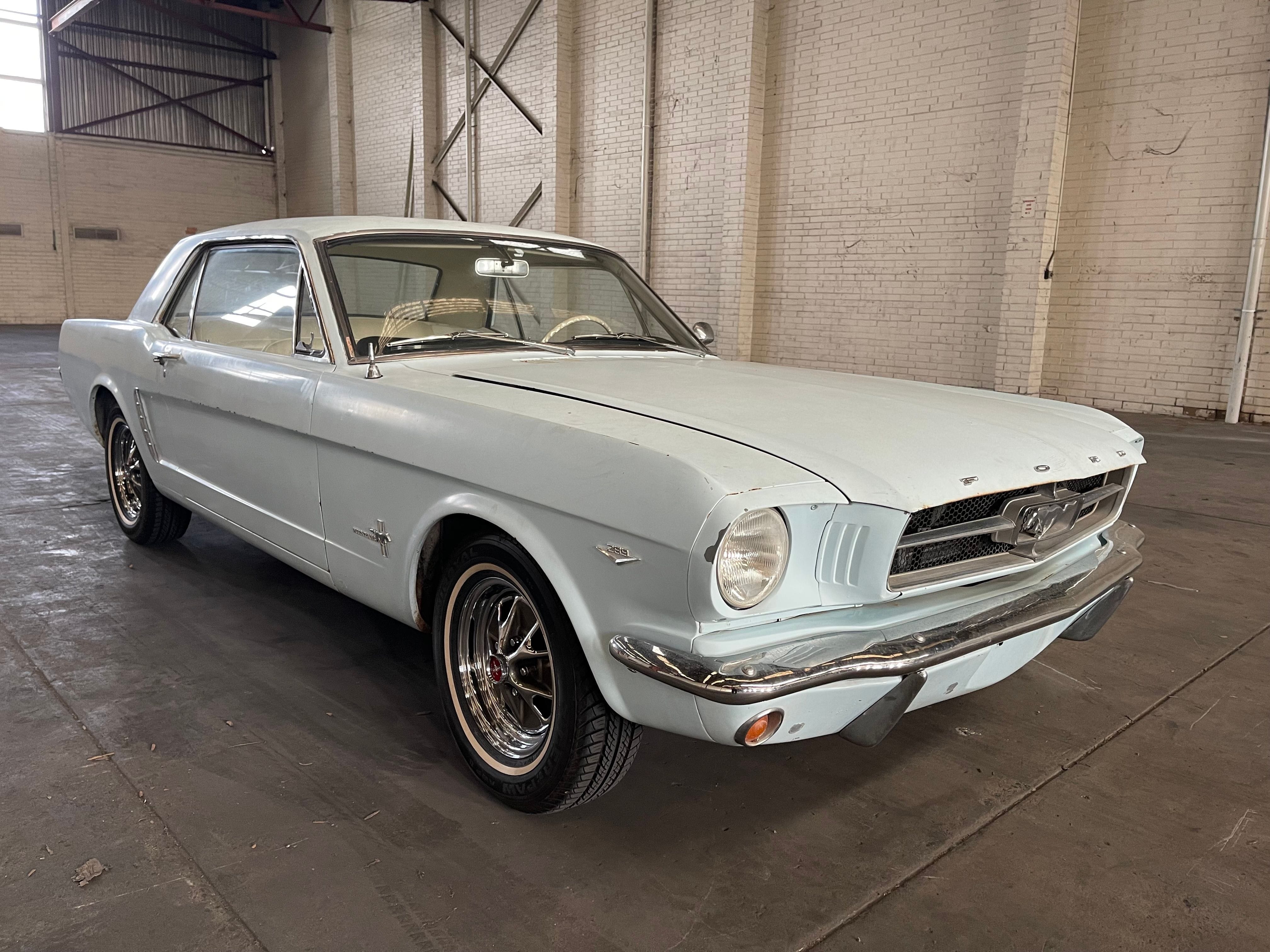 White 1965 Ford Mustang Coupe with minor wear on the front.